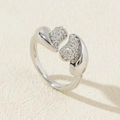 Detail of adjustable silver ring with twin hearts featuring half-pave cubic zirconia - Style 4