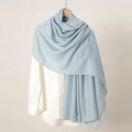 Close-up of soft light blue silk scarf texture with elegant draping on a white shirt - Light Blue