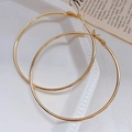 Chic golden large hoop earrings for women with high-gloss metallic finish and clasp - 7cm / Gold