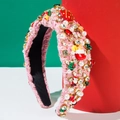 Detail eines rosa Tweed-Weihnachtsstirnbands mit Perlen, Strass und weihnachtlichen Motiven - Rosa