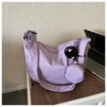 Detail of purple crescent shoulder bag with round coin purse and plush charm on a desk - With Pendant / Purple
