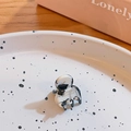Mini hair claw clip with black and white marble cow print texture on a decorative plate - Cow Print