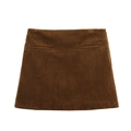 Detailed close-up of brown corduroy fabric and faux pockets on an A-line mini skirt - XS / Caramel color