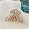 Macro shot of marble texture acetate hair claw with rainbow rhinestones and BEAR text - Pink White Agate - Rhinestone