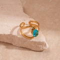 Detail of gold double-layered textured ring with an oval blue zircon on stone - Gold Double Layer Cross