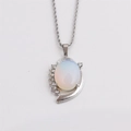 Close-up of silver twist chain necklace with opal pendant and dolphin detail - Milky White
