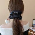 Elegant black satin pleated scrunchie hair tie worn on a low ponytail by a model - Black (16# Scrunchie-Black-Width 13.5cm)