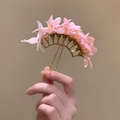 Detail view of a golden hair pin with delicate pink fabric flowers and water drops deco - Single Piece / Pink