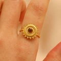 Detaillierte Makroansicht eines goldenen Sonnenrings mit braunem Stein am Finger - Goldener Sonnen-Tigerauge-Ring Stil (WG-0418)