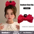 Large red satin bow hair claw clip for women featuring 16cm ribbon and 11cm black grip - Red Satin Bow Cross Style Claw Clip / Red