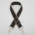 Detail of adjustable woven wide bag strap with contrast trim and gold metal swivel hooks - Coffee with Beige Edge / Silver Hardware