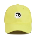 Close-up of Tai Chi Yin Yang embroidery and SWIMMING text on yellow baseball cap - Adjustable / Light Yellow