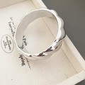 Macro shot of silver minimalist wavy ring with a mirror-polished finish on a jewelry tray - Continuous Scalloped Wave Style (5#)