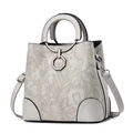 Detailed view of white floral embossed leather handbag with metal hexagonal clasp. - Gray