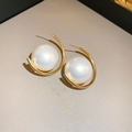 Detailed view of large white pearl nestled in a gold C-shaped metal earring setting - Gold Curved Bracket Large Pearl Earrings (14#)