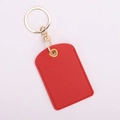 Detail of red faux leather key fob with golden metal ring and lobster clasp - Square / Red