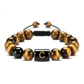 Close-up of 10mm tiger eye stone bracelet featuring a hand-woven cord and golden letter C - Letter C