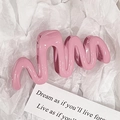 Pink wavy hair claw clip with glossy jelly finish on minimalist white background - Pink