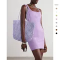 Violet handmade woven tote bag with woven straps and textured pattern worn by a model - Purple