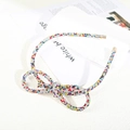 Close-up of colorful rhinestone bow headband with glittering crystals and gold tips - Figure 8 Knot Full Rhinestone Headband / Mixed Colors