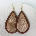 Detailed view of wood teardrop earrings with gold-textured animal fur on white plate - Wood/Gold Textured Hair