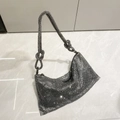 Macro shot of silver crystal rhinestone bag with knotted handle detail on marble floor - Gunmetal