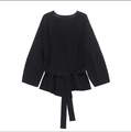 Detalle de jersey de punto negro con cintura cruzada anudada y bajo de tipo peplum - S / Negro