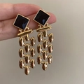 Detail view of gold fringe drop earrings featuring square black gemstones in a vintage style - Chain Drop Earrings