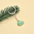 Detailed close-up of a mint green shell keychain with gold edges and silver chain - Style 6 (Mint Green Gold Edge Shell)