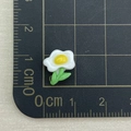 Detailed view of 1.5cm resin flower charm for nail art and jewelry on a measuring mat - Single Plumeria