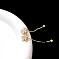 Detail of elegant gold flower drop earrings with white petals and fine tassel chains - White Gold Flower Chain (Single)