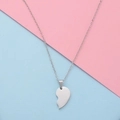 Macro detail of silver half-heart pendant with polished mirror finish and cable chain - Large Steel Single Piece