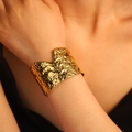 Wide gold-tone hammered stainless steel open cuff bracelet with leaf-inspired texture - Punctate Texture