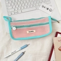 Detail of mint green and pink mesh pencil case on a laptop keyboard in a study setting - Light Pink