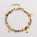 Detail of bohemian gold layered bracelet with multi-color beads and gold star charms - Small Eight-pointed Star