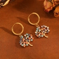 Golden Tree of Life earrings with colorful rhinestones on a warm textured background - Gold Colorful Tree Earrings (T031)