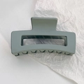 Detail view of large matte grey-green rectangular hair claw clip with cutout design - Green