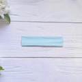 Elastic high-stretch yoga headband in light blue color on a white wooden background - Light Blue