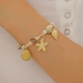 Detail of beach style bracelet with shell and starfish charms on a beaded strand - KC Gold Bracelet (S185)