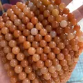 Macro shot of polished 8mm orange natural sunstone beads for DIY jewelry making - Red Aventurine / 4mm (approximately 90 Beads) 38cm Long