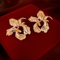 Detailed view of golden flower earrings with petal texture on deep red velvet - Gold (925 Sterling Silver Earring Post)