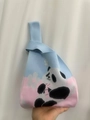 Knit knot wrist bag featuring panda and floral patterns in blue and pink color blocks - Two-Tone