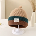 Close-up of color-block knitted beanie for kids with decorative fabric patch and top knot - 1-3 Years / Khaki