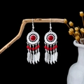 Detailed close-up of Bohemian drop earrings with red beads and metal feather tassels - Retro Silver Red Dreamcatcher Feather(E5986-1)