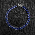 Macro view of blue zircon tennis bracelet with silver prong setting and fold-over clasp - 5mm-16cm / Navy Blue Zirconia