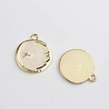 Detailed macro view of gold-plated star and moon enamel charms showing front and back texture - White Star
