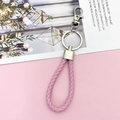 Roze gevlochten lederen sleutelhanger met metalen ring en veerhaak op decoratie - Roze