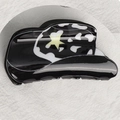 Chic black hat-shaped hair claw with white cow pattern and a yellow star detail - Black White Cow Hat Style