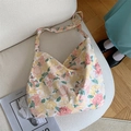 Detailed texture of floral canvas tote bag showing high-quality fabric on beige sofa - Yellow Peony