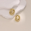 Elegant 18K gold-plated irregular spiral hoop earrings displayed on white textured stone - EH389 Oval Multi-layer Spiral
